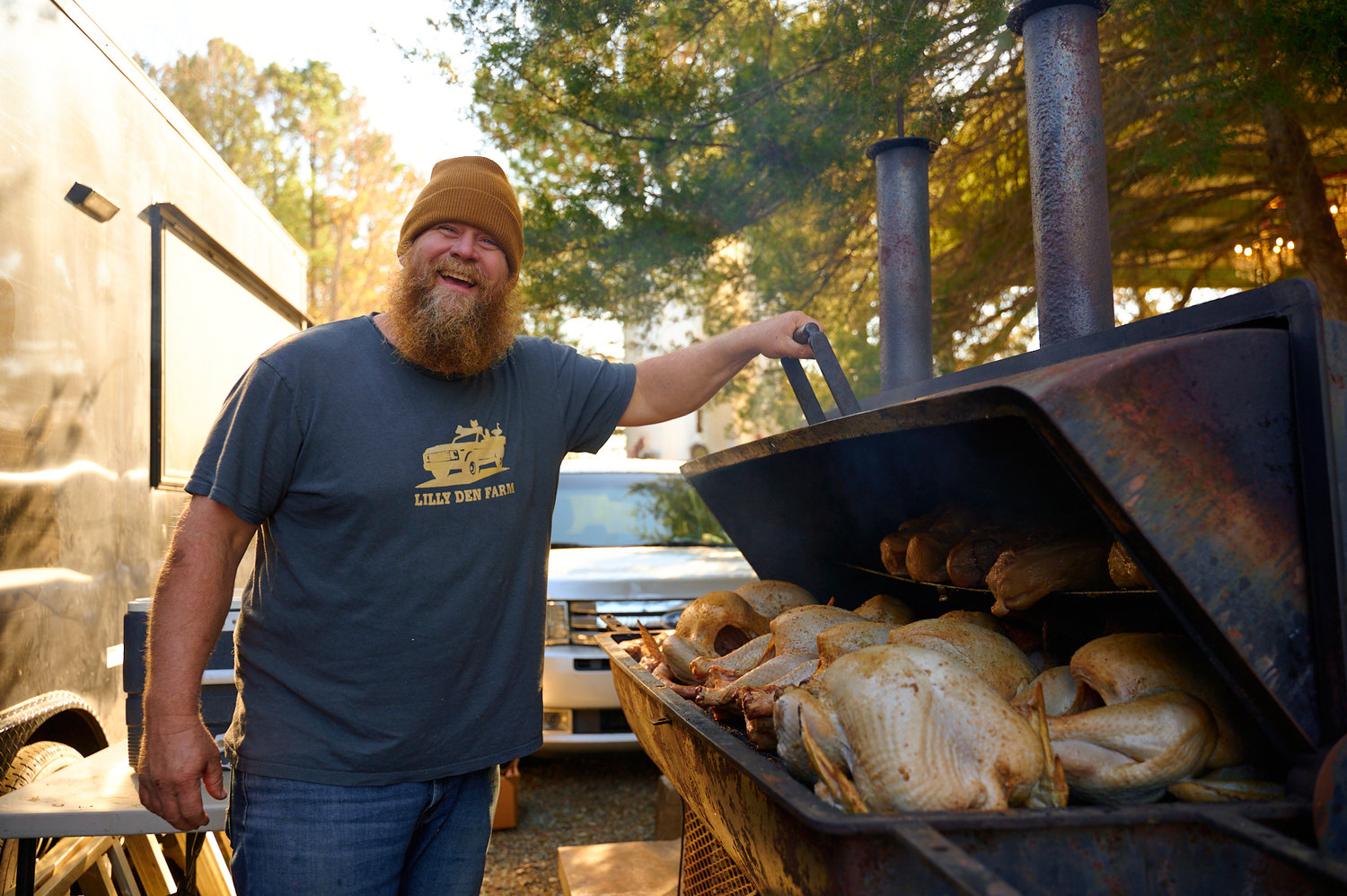 Lilly Den Farm owner Tucker Withington smokes turkeys at the Pittsboro Farmers Market. The Goldston farm begins prep work at the start of the year for the more than 100 holiday turkeys it sells around Thanksgiving.